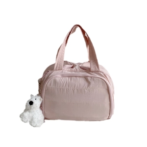 Pink quilted travel organizer bag with handle and cute white puppy keychain accessory