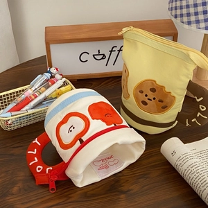 Close-up of creative coffee cup shaped pencil bags with apple and cookie embroidery