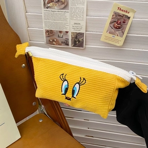 Detailed close-up of yellow knitted Tweety Bird stationery pouch with zipper closure