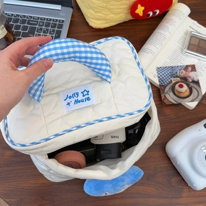 Quilted white cosmetic bag with blue checkered handles and cute cat plush pendant