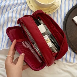 Deep red high-capacity canvas pencil case with multi-layer zippers in a lifestyle setting