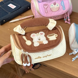 Detail of macaron pencil case featuring bear embroidery and corduroy texture details