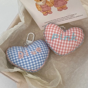 Detail of pink and blue checkered heart charms with cute embroidery for bags