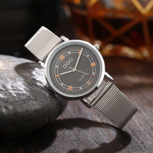 Detail of silver mesh strap watch with Roman numeral dial and sparkling diamond accents
