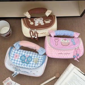 Detailed view of macaron color pencil cases with cute embroidery and fabric handles