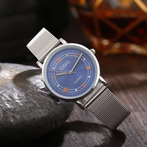 Detail of silver mesh strap watch with navy blue Roman dial and crystal accents