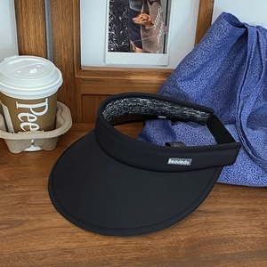 Detail of black open top sun hat with wide brim and Beauledo brand tag on quick-dry fabric
