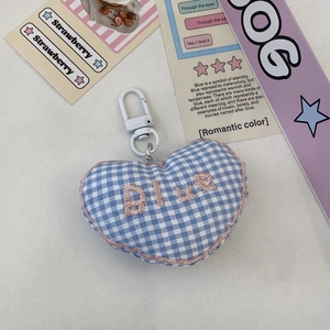 Detail of blue gingham heart keychain featuring pink embroidery and a white plastic clip