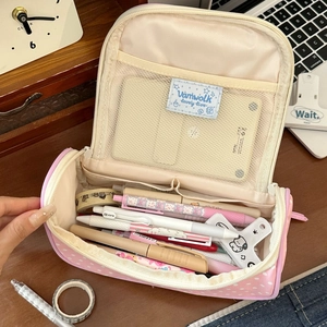 Pink polka dot canvas pencil case with large capacity and mesh pocket on desk