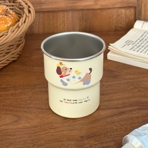 Detail of cream stainless steel dachshund cup with matte finish and cute cartoon illustration