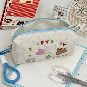 Quilted white puppy baby makeup bag with embroidery and light blue zipper closure