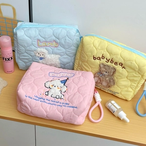 Detailed view of quilted cotton makeup bags with cute animal embroidery and zippers