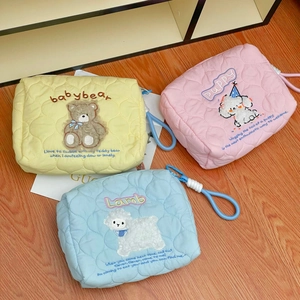 Detailed view of quilted cotton makeup bags with cute bear, dog, and sheep embroidery