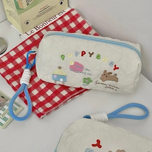 Quilted beige cosmetic bag with puppy embroidery and light blue zipper handle