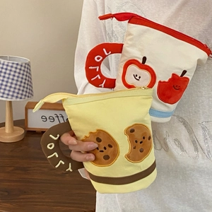 Detail of cute cup-shaped canvas pencil cases with embroidery and zipper closure