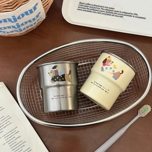 Close-up of stainless steel dachshund mugs on a metal tray for bathroom use