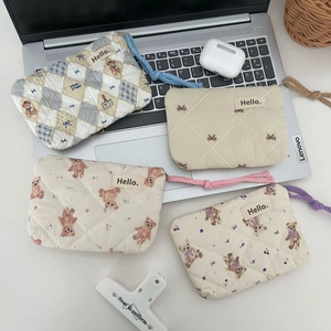 Set of four cute quilted cotton coin purses with floral and bear patterns for storage