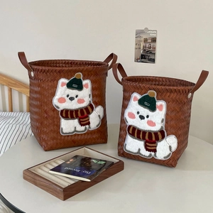 Detail of faux rattan laundry baskets with leather handles and cute puppy embroidery