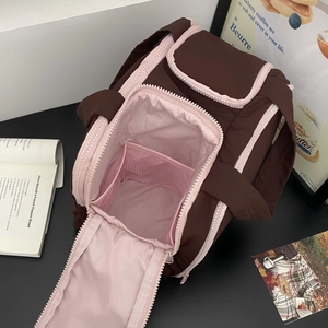 U-shaped large opening of quilted travel cosmetic bag with pink mesh divider detail
