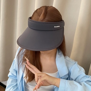 Close-up of wide brim dark grey sun visor with white Beauledo letter embroidery