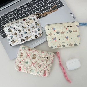 Set of three quilted mini cosmetic pouches with cute animal prints and zipper closure