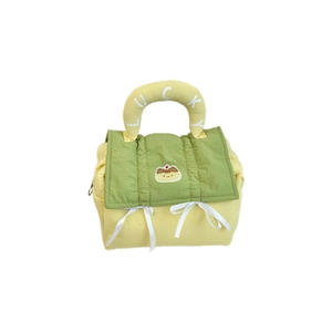 Quilted yellow and green Lucky makeup bag with cute cartoon patch and white bow details