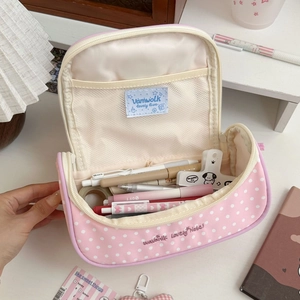 Detail showing the large capacity macaron pink polka dot pencil case with mesh dividers
