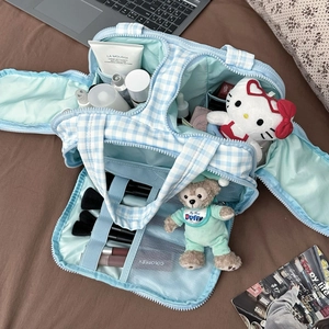 Blue checkered large capacity makeup bag with multi-compartment interior for travel storage