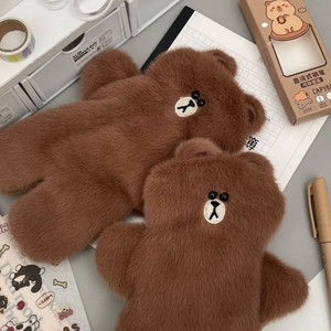 Detailed view of brown plush bear pencil cases in two sizes with soft fur texture