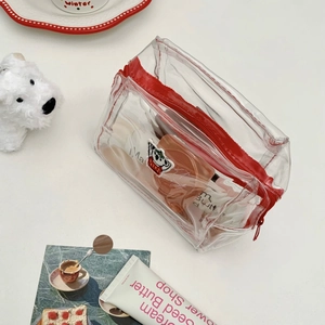 Detail of transparent PVC koala pouch with red zipper and cute puppy embroidery