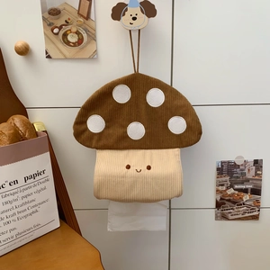 Detail of hanging mushroom tissue box made of brown corduroy on a white wall hook