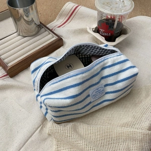 Detail of blue striped waffle fabric toiletry bag with soft towel texture and inner lining
