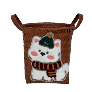 Brown woven storage basket with white puppy patch and leather handles on white background