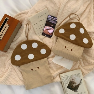 Detail of mushroom corduroy tissue box with white dots and smile embroidery on cozy blanket