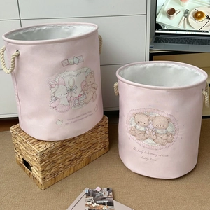 Detail of pink canvas laundry baskets in two sizes featuring cute bear and rabbit prints