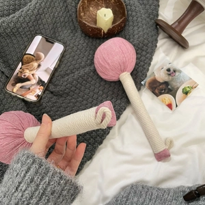 Close-up of pink herb-filled massage hammer with woven rope handle for wellness