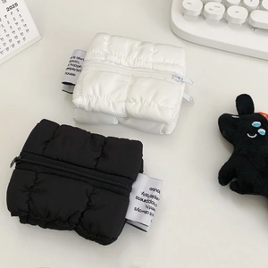 Minimalist cloud puff quilted coin purses in black and white with zipper and woven label