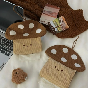 Detail of mushroom-shaped corduroy tissue box cover with cute embroidery on white bedding