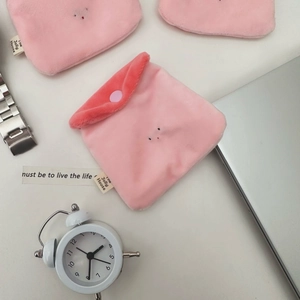 Detail of pink plush strawberry pudding coin purse with snap closure and soft texture