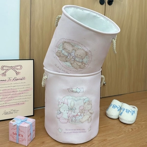 Detail of pink canvas laundry baskets with vintage bear prints and sturdy rope handles
