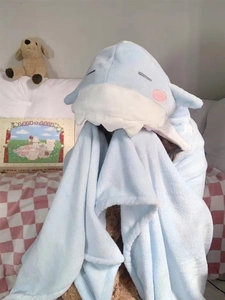 Close-up of soft shark hooded blanket featuring embroidered eyes and plush fin details