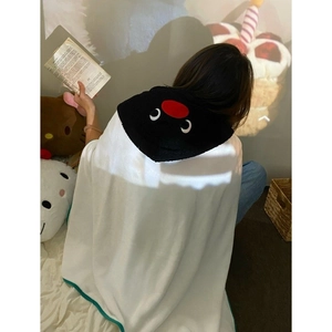 Detailed view of the cute cartoon penguin hooded blanket with soft plush white fabric