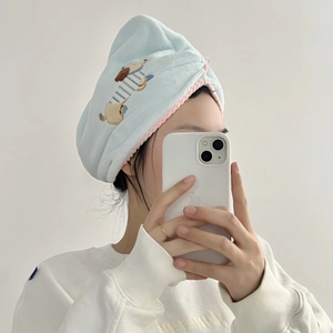 Close-up of cute cartoon puppy embroidery on soft blue microfiber hair drying cap
