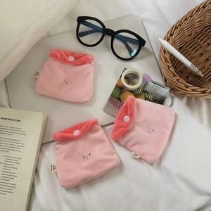 Three pink plush pouches with button closure and cute embroidery on a white background