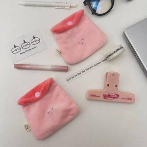 Flat lay of pink plush strawberry pudding mini pouches for coins and earphones