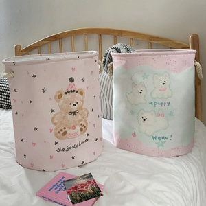 Pink canvas laundry hamper with bear and puppy prints and sturdy thick rope handles