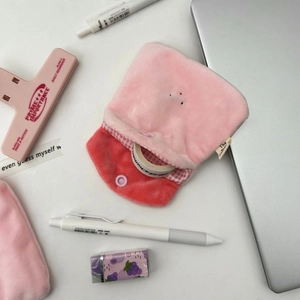Inside view of pink plush coin purse showing red checkered lining and snap button