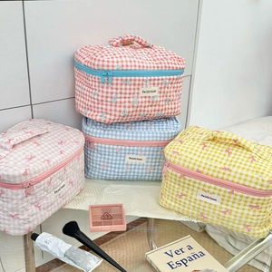 Quilted checkerboard cosmetic bags with pink bow prints and convenient top handles
