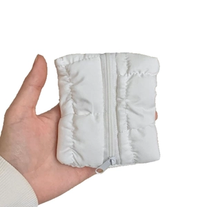 White quilted mini cloud coin purse and card holder with zipper closure in hand