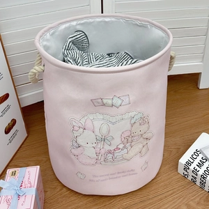 Detail of pink cartoon laundry basket with thick rope handles and soft animal graphics
